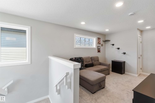 This room features neutral-toned walls, recessed lighting, and soft carpeting - 29 Gambel Loop, Spruce Grove, AB - Indoor