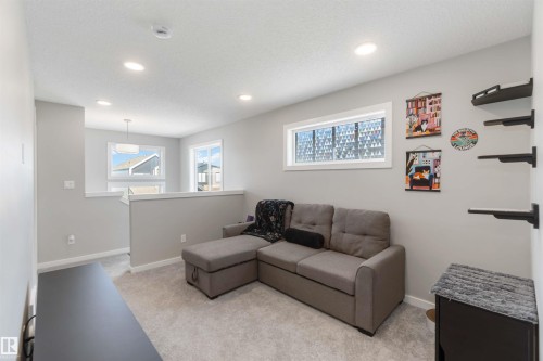 The property features a bright living area with recessed lighting, light-colored walls, and carpeting - 29 Gambel Loop, Spruce Grove, AB - Indoor