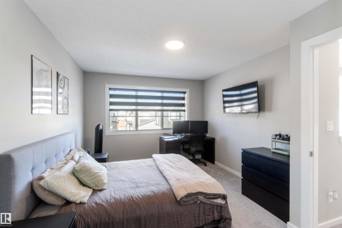 This room features neutral-toned walls and carpet, with a window providing exterior views - 29 Gambel Loop, Spruce Grove, AB - Indoor Photo Showing Bedroom