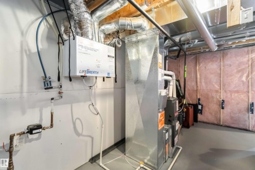 Basement area featuring a furnace unit, exposed ductwork, and insulation on the walls - 29 Gambel Loop, Spruce Grove, AB - Indoor Photo Showing Basement
