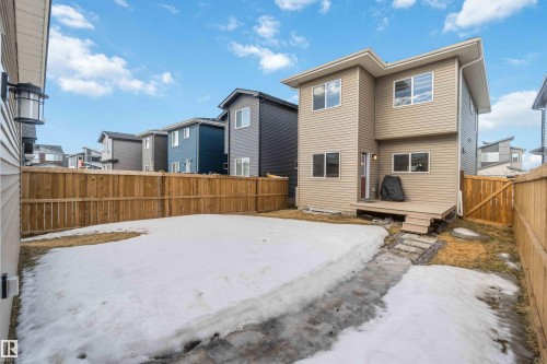 The property features a private yard with a wooden fence and a raised deck with steps - 29 Gambel Loop, Spruce Grove, AB - Outdoor
