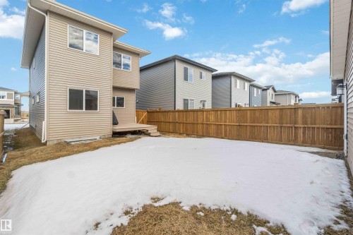 The property features a two-story exterior with horizontal siding, a wooden deck, and a fenced yard - 29 Gambel Loop, Spruce Grove, AB - Outdoor With Exterior