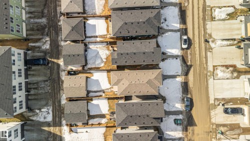 Aerial view of the neighborhood featuring properties with dark-colored roofs and visible driveways - 29 Gambel Loop, Spruce Grove, AB - 