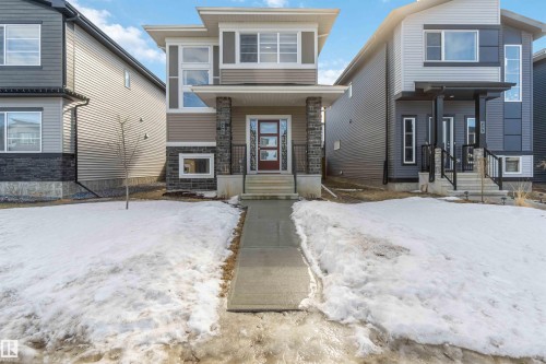 The property features a modern facade with varying siding materials and a prominent front entrance with a covered porch - 29 Gambel Loop, Spruce Grove, AB - Outdoor With Facade
