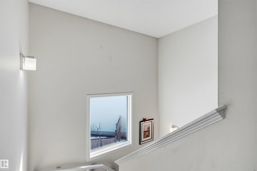 Interior view featuring bright walls, a window, and wall-mounted lighting fixtures - 2812 16 Avenue, Edmonton, AB - Indoor