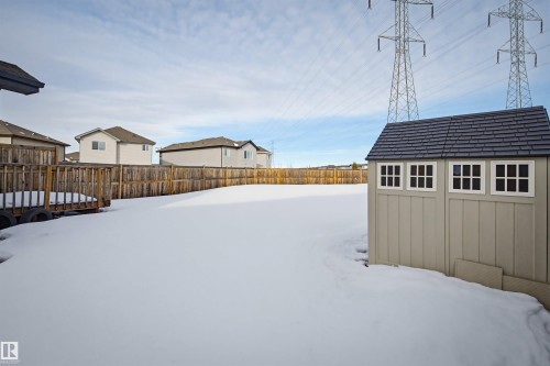 The property features a spacious backyard with a wooden fence and a storage shed with decorative windows - 2812 16 Avenue, Edmonton, AB - Outdoor With Exterior