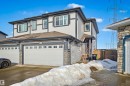 This property features a two-story exterior with light-colored siding and dark trim, complemented by stone accents - 2812 16 Avenue, Edmonton, AB  - Outdoor 