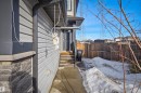 The property features a grey exterior with horizontal siding and a stone accent foundation - 2812 16 Avenue, Edmonton, AB  - Outdoor 