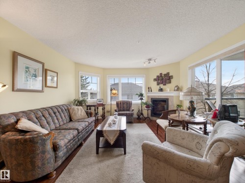 218 2045 Grantham Crest, Edmonton, AB - Indoor Photo Showing Living Room With Fireplace