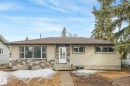 The property features a ranch-style exterior with a stucco and stone facade, a brown shingle roof, and a front walkway leading to the entrance - 15704 91 Avenue, Edmonton, AB  - Outdoor 