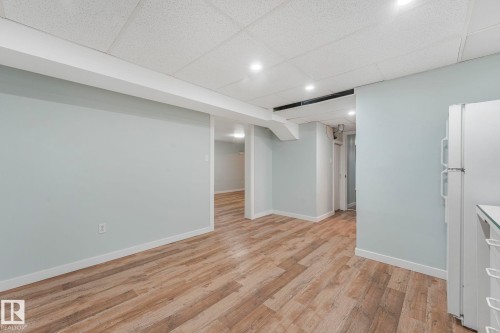 Finished lower level with recessed lighting, light wood-style flooring, and a drop ceiling - 15704 91 Avenue, Edmonton, AB - Indoor