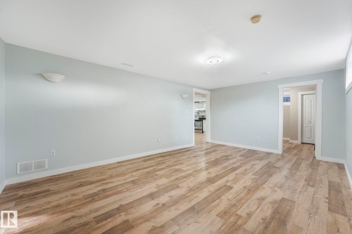 Living space featuring light-colored walls, wood-style flooring, and recessed lighting - 15704 91 Avenue, Edmonton, AB - Indoor Photo Showing Other Room