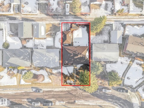 Aerial view of the property, featuring a residential building with a dark roof and surrounding grounds with areas of green foliage and a paved driveway - 15704 91 Avenue, Edmonton, AB - Outdoor With View