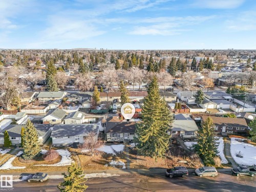 Aerial view showcasing the property situated within a tree-lined neighborhood - 15704 91 Avenue, Edmonton, AB - Outdoor With View