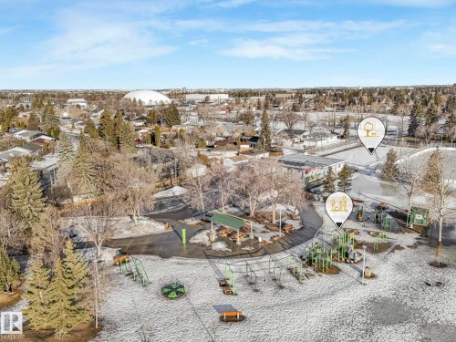 Aerial view showcasing the neighbourhood with a playground area, trees, and residential properties - 15704 91 Avenue, Edmonton, AB - Outdoor With View