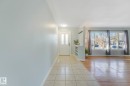 Entryway featuring tiled flooring, a white front door with vertical glass inserts, and a built-in storage unit - 15704 91 Avenue, Edmonton, AB  - Indoor Photo Showing Other Room 