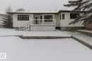 The property features a white exterior with dark-framed windows, a white deck with railings, and steps leading to the yard - 9971 178 Avenue, Edmonton, AB  - Outdoor 