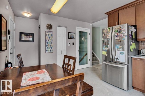 Kitchen area featuring wood cabinets, stainless steel appliances, and tile flooring - 3523 18A Avenue, Edmonton, AB - Indoor