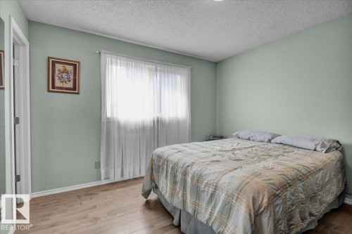 The room features light-colored walls and light wood flooring, providing a bright and airy atmosphere - 3523 18A Avenue, Edmonton, AB - Indoor Photo Showing Bedroom