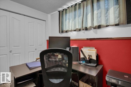 This bedroom features a window with horizontal blinds, and a closet with bi-fold doors - 3523 18A Avenue, Edmonton, AB - Indoor