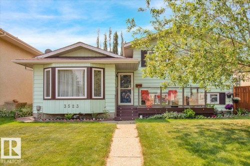 This property features a front lawn with a concrete walkway and a bay window - 3523 18A Avenue, Edmonton, AB - Outdoor With Deck Patio Veranda