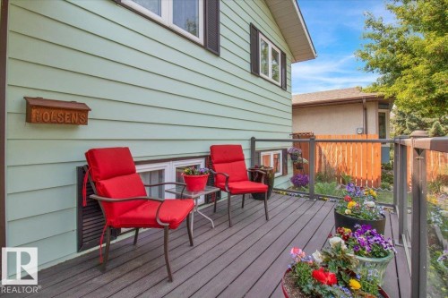 The property features a private deck with a glass-paneled railing, offering a pleasant outdoor space - 3523 18A Avenue, Edmonton, AB - Outdoor With Deck Patio Veranda With Exterior