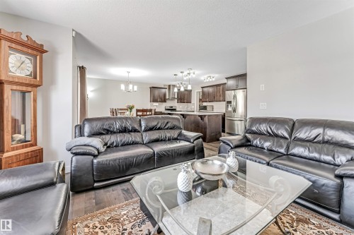 The living area features hardwood flooring and an inviting open concept design that extends to the kitchen and dining areas - 2244 21 Avenue, Edmonton, AB - Indoor Photo Showing Living Room