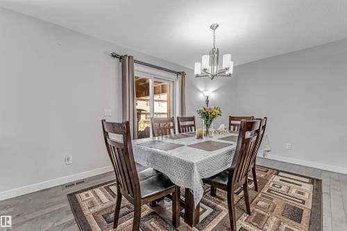 This dining area features light grey walls and light-colored flooring - 2244 21 Avenue, Edmonton, AB - Indoor Photo Showing Dining Room
