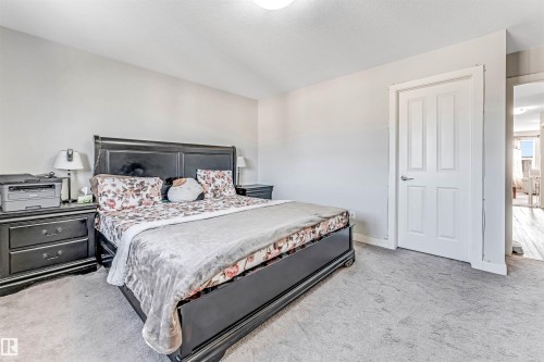 This sleeping area features light-colored walls and grey carpeting - 2244 21 Avenue, Edmonton, AB - Indoor Photo Showing Bedroom
