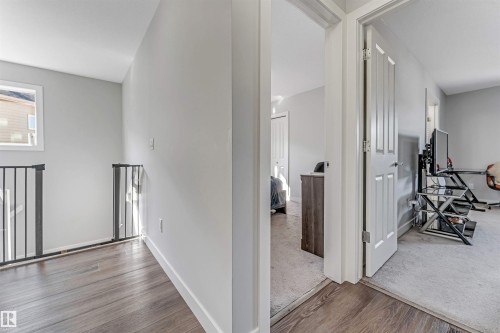 This property features light gray walls, dark wood flooring, and white trim - 2244 21 Avenue, Edmonton, AB - Indoor Photo Showing Other Room