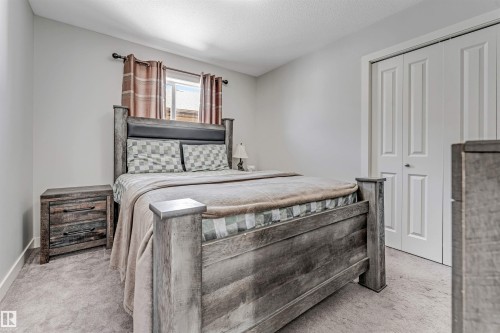 This room features light grey walls and carpeted flooring - 2244 21 Avenue, Edmonton, AB - Indoor Photo Showing Bedroom