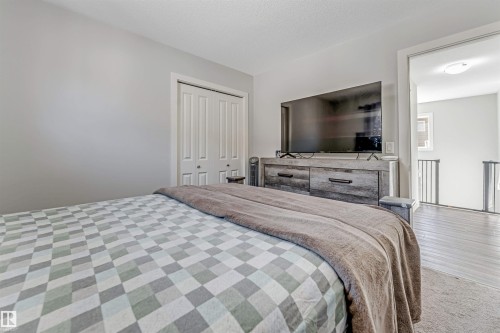 This room features light-colored walls and a closet with bi-fold doors - 2244 21 Avenue, Edmonton, AB - Indoor Photo Showing Bedroom