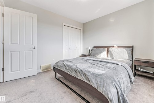 This room features a neutral color palette, light gray walls, and light gray carpeting - 2244 21 Avenue, Edmonton, AB - Indoor Photo Showing Bedroom