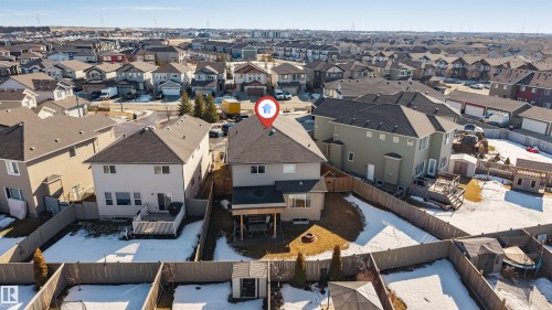 The property features a spacious backyard with a deck and a fire pit, enclosed by a wooden fence - 2244 21 Avenue, Edmonton, AB - Outdoor