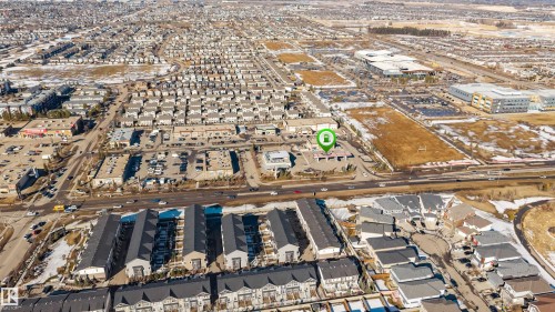Aerial view showcasing the surrounding area with residential buildings, commercial properties, and a prominent road - 2244 21 Avenue, Edmonton, AB - Outdoor With View