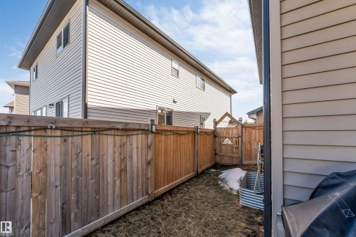 The property features a private backyard with a wooden fence and a wooden gate - 2244 21 Avenue, Edmonton, AB - Outdoor With Exterior