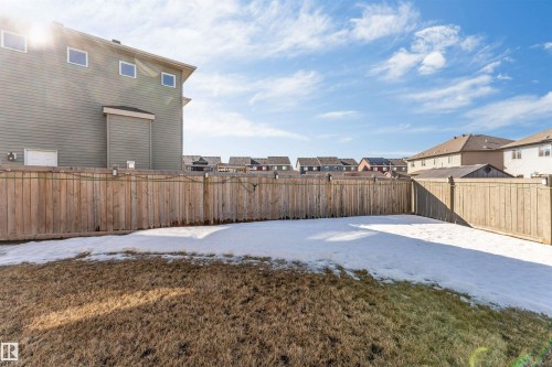 The property features a fenced yard with a combination of grass and snow cover - 2244 21 Avenue, Edmonton, AB - Outdoor