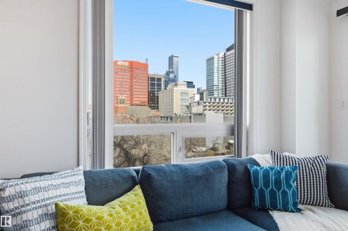 The property features expansive windows providing abundant natural light and views of the cityscape - 601 10504 99 Avenue, Edmonton, AB - Indoor Photo Showing Bedroom