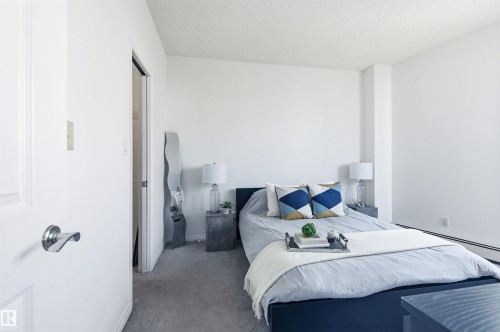 This bedroom features white walls, carpet flooring, and a white ceiling - 601 10504 99 Avenue, Edmonton, AB - Indoor Photo Showing Bedroom