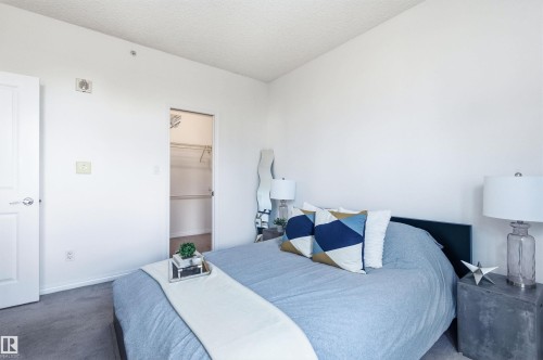 This room features white walls, carpeted flooring, and a closet with shelving - 601 10504 99 Avenue, Edmonton, AB - Indoor Photo Showing Bedroom