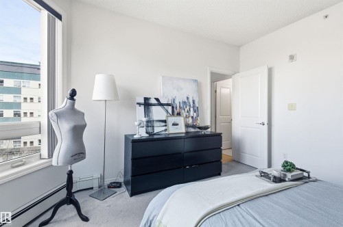 The room features a window providing natural light, light-colored walls, and carpet flooring - 601 10504 99 Avenue, Edmonton, AB - Indoor Photo Showing Bedroom