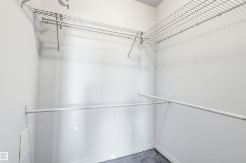 The property offers a closet featuring white walls, wire shelving, and hanging rods - 601 10504 99 Avenue, Edmonton, AB - Indoor With Storage
