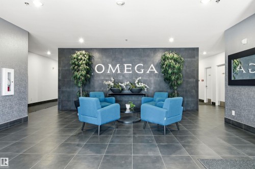 Lobby area featuring large format floor tiles, a textured accent wall, and recessed ceiling lighting - 601 10504 99 Avenue, Edmonton, AB - Indoor Photo Showing Other Room