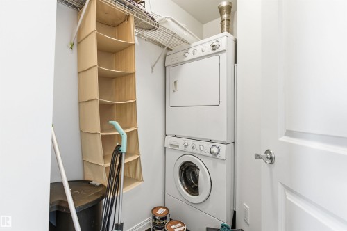 Dedicated laundry area featuring a stacked washer and dryer - 601 10504 99 Avenue, Edmonton, AB - Indoor Photo Showing Laundry Room