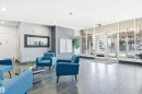 Inviting lobby area featuring tiled flooring, comfortable blue armchairs, and a decorative mirror - 601 10504 99 Avenue, Edmonton, AB  - Indoor 