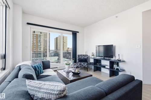 The living area features light-colored flooring and white walls, creating a bright and airy atmosphere - 601 10504 99 Avenue, Edmonton, AB - Indoor Photo Showing Living Room
