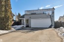 The property features a private driveway leading to an attached garage with a white door - 8807 31 Avenue, Edmonton, AB  - Outdoor 