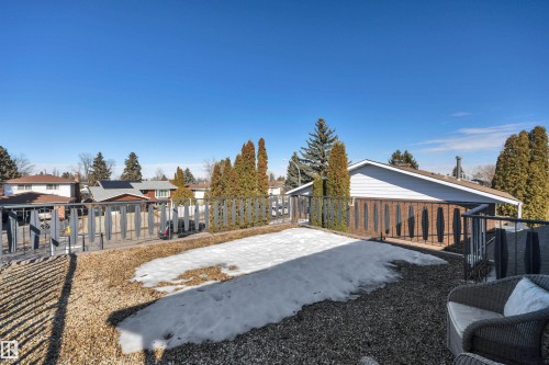 The property features a gravel ground cover and a black railing - 8807 31 Avenue, Edmonton, AB - Outdoor