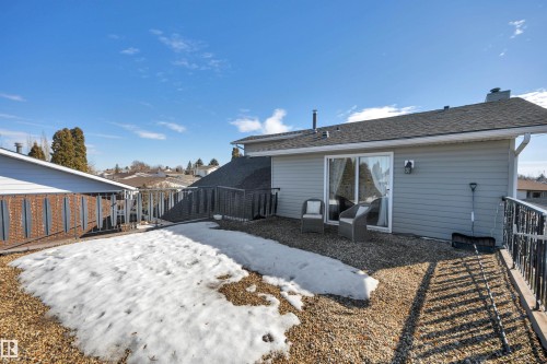The property features a deck area with a gravel surface, a sliding glass door, and exterior siding - 8807 31 Avenue, Edmonton, AB - Outdoor With Exterior