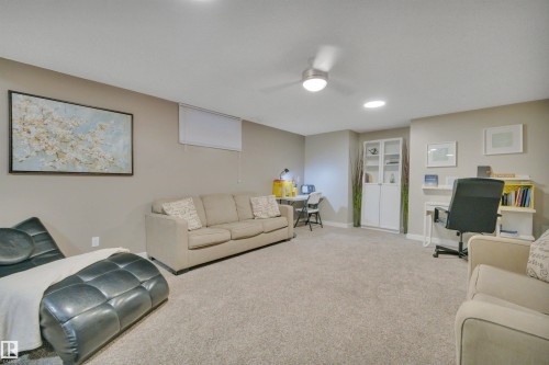 Spacious room with light-colored carpeting, recessed lighting, and a ceiling fan - 8807 31 Avenue, Edmonton, AB - Indoor